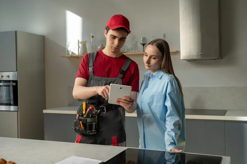 An electrician explaining the project cost and fees to a homeowner