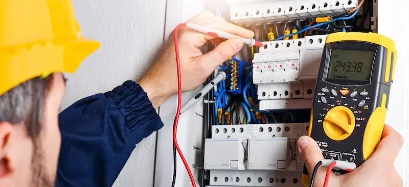 An electrician on a service call completing the work